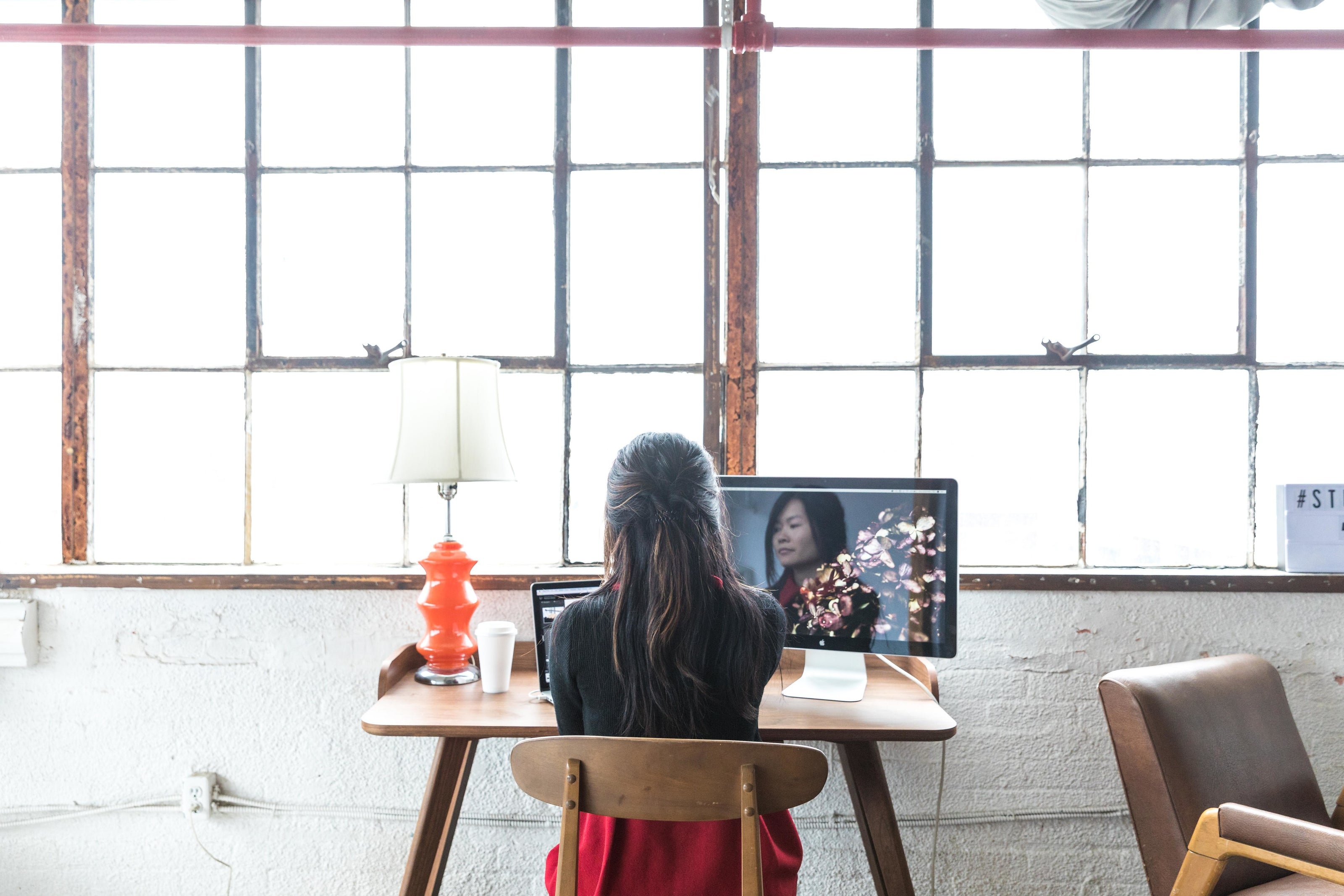  women  sites at her desk in front